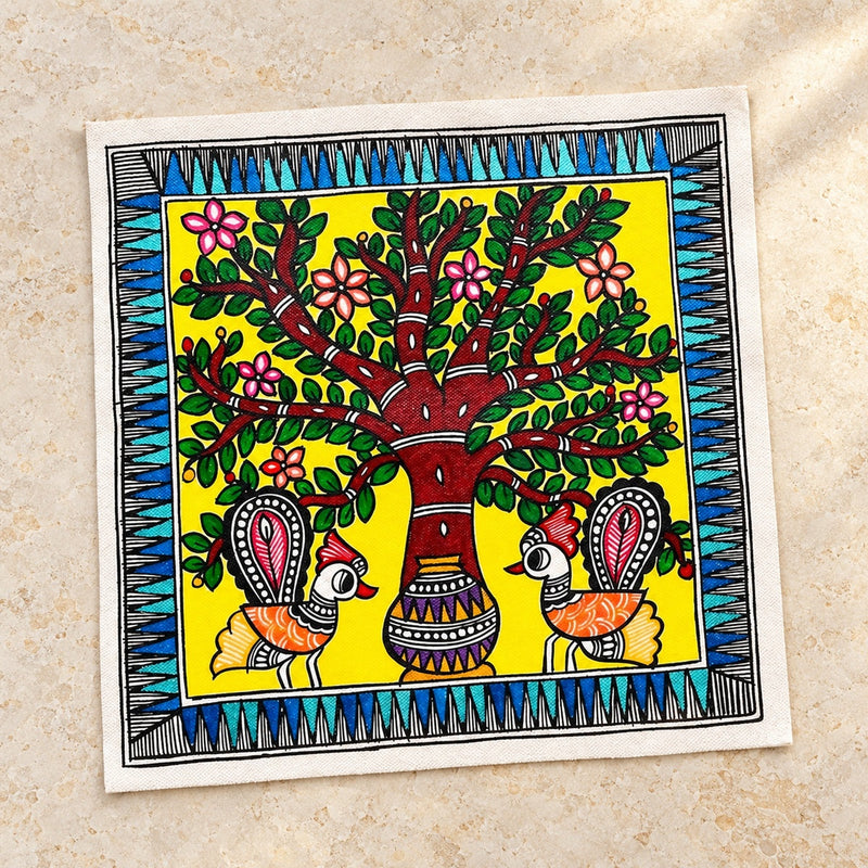 Unframed Madhubani-inspired peacock and tree painting on cloth canvas displayed on warm ivory limestone