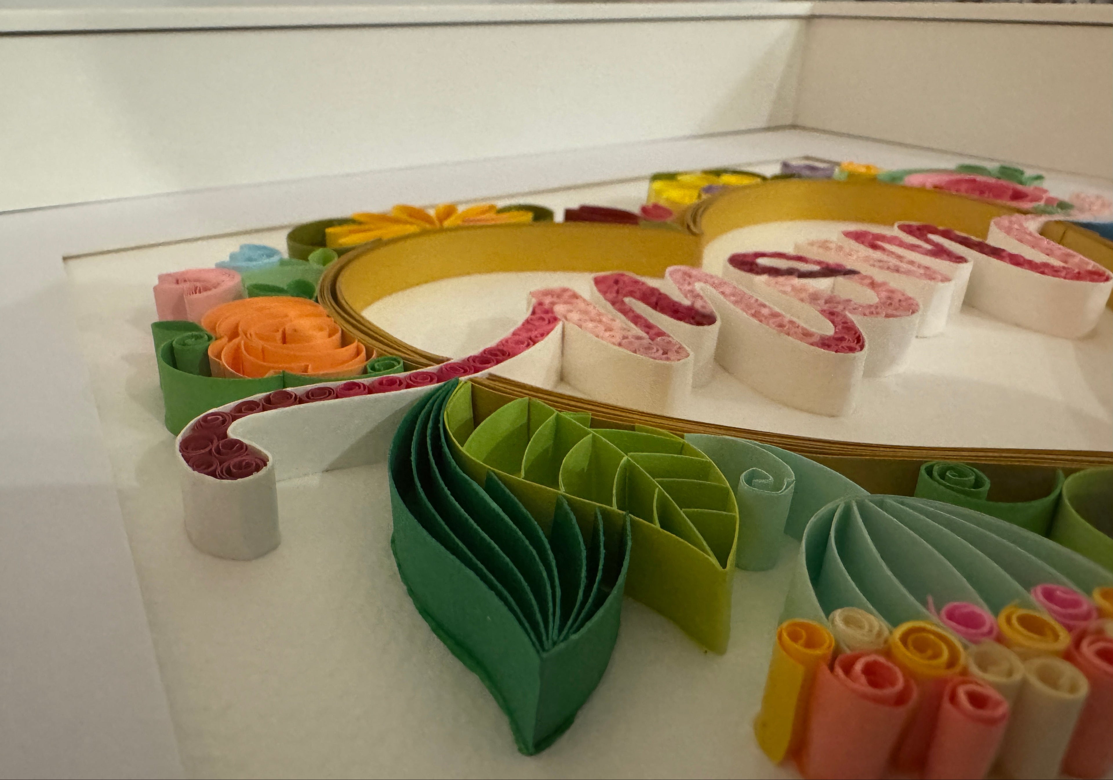 Close up of handmade paper quilling floral design on Mum wall art