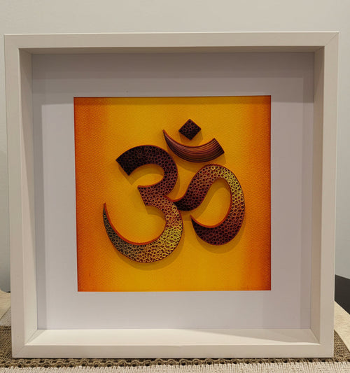 Framed artwork with a decorative symbol on an orange background