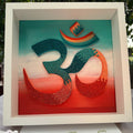 Handcrafted spiritual OM paper quilling artwork in teal, aqua, coral and warm orange tones, framed in white MDF