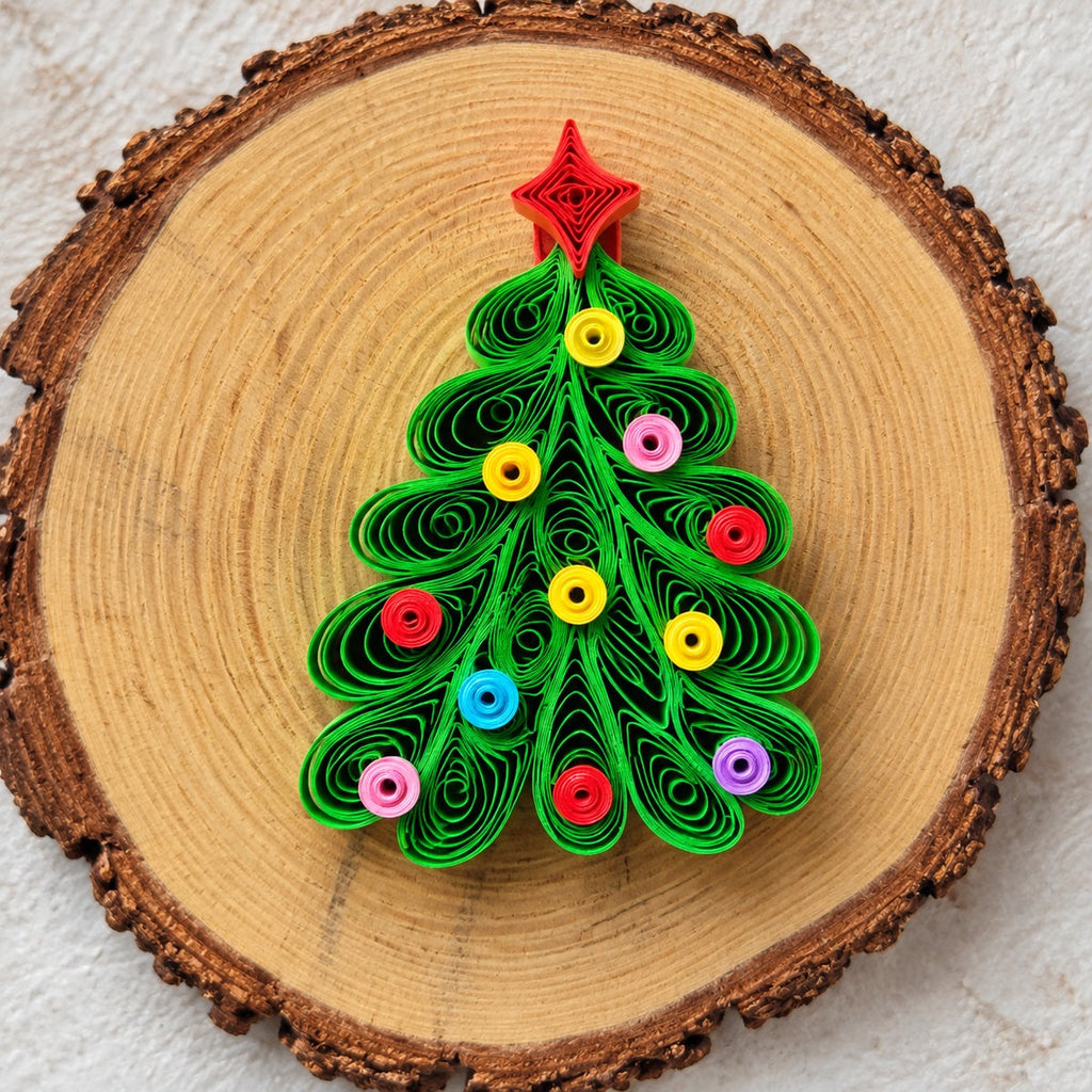 Handmade Christmas tree paper quilling fridge magnet displayed on a natural wood slice.