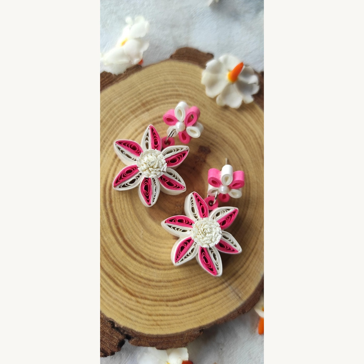 Handcrafted pink and white paper quilling flower stud drop earrings with two-tone petals and pearl-look accents.