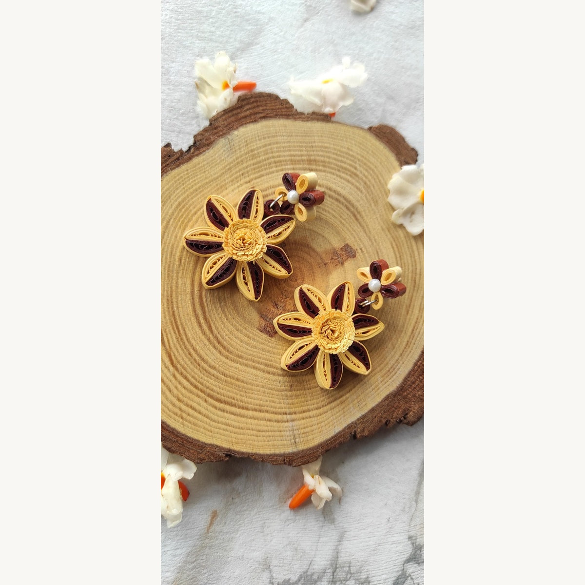 Handcrafted yellow and brown paper quilling flower stud drop earrings with two-tone petals and pearl-look accents.