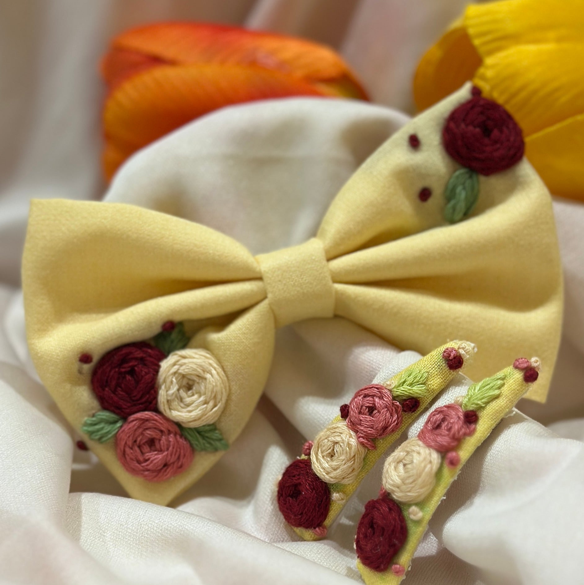 Handmade embroidered floral hair bow in yellow golden and matching hair clip set featuring artisan rose embroidery and botanical detailing, beautifully crafted for gifting and special occasions.
