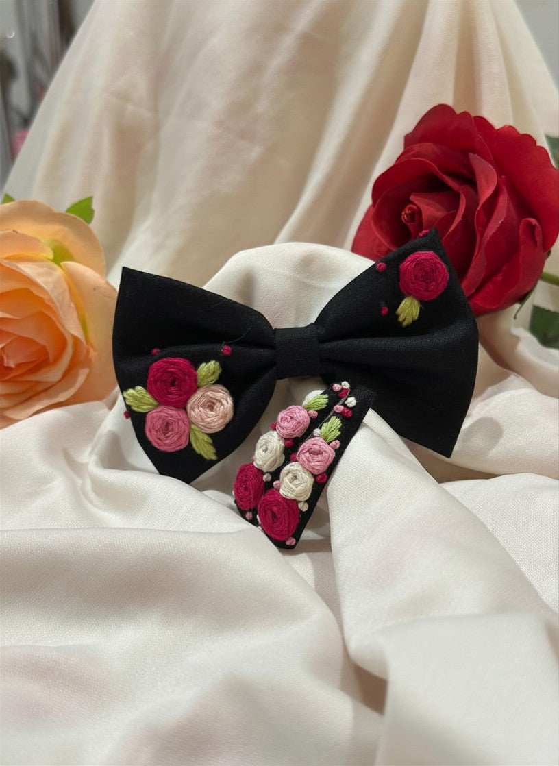 Handmade embroidered floral hair bow in black and matching hair clip set featuring artisan rose embroidery and botanical detailing, beautifully crafted for gifting and special occasions.