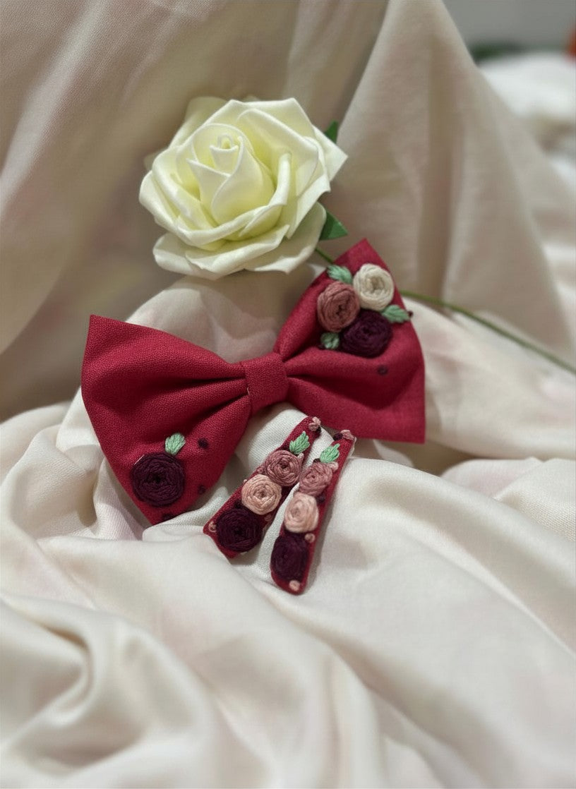 Handmade embroidered floral hair bow in ruby bloom and matching hair clip set featuring artisan rose embroidery and botanical detailing, beautifully crafted for gifting and special occasions.
