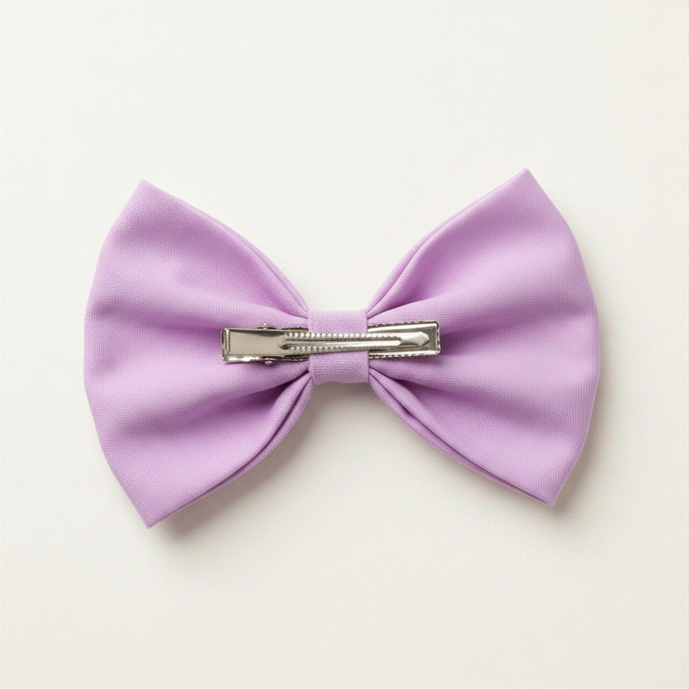 Alligator clip fastening on handmade embroidered lavender hair bow — secure hold for all hair types