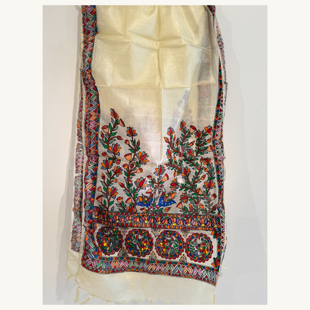 Full length ivory cream Madhubani stole showing multicoloured peacocks and floral borders