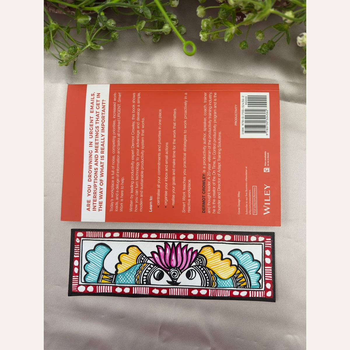 Hand-painted Madhubani Lotus Companions bookmark with two turquoise and yellow fish beneath a pink lotus, beside a book for size reference. Book not included.