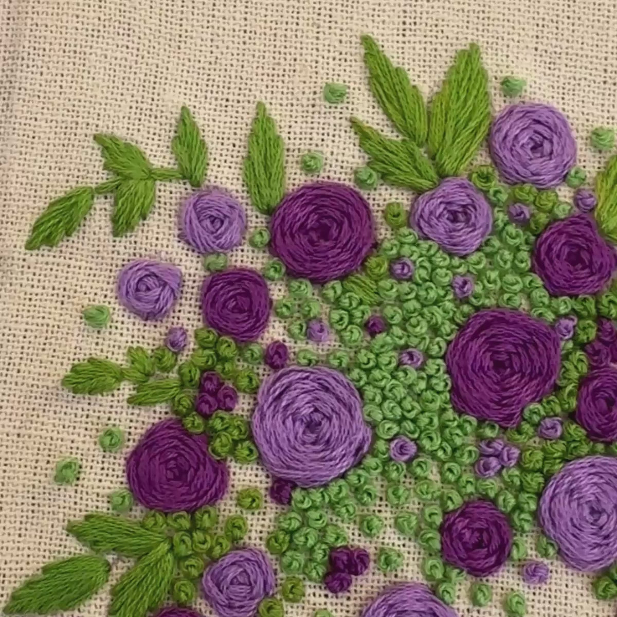 Hand embroidered floral journal with lilac and violet rose bouquet stitched on a pale lemon-yellow linen cover.