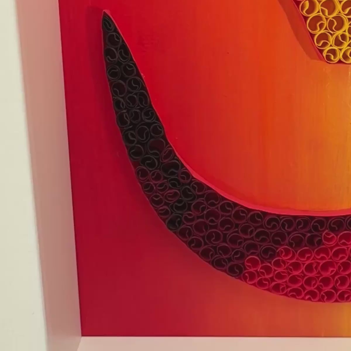 Handcrafted paper quilling OM artwork in red, orange, gold and black sunset tones, framed in white MDF