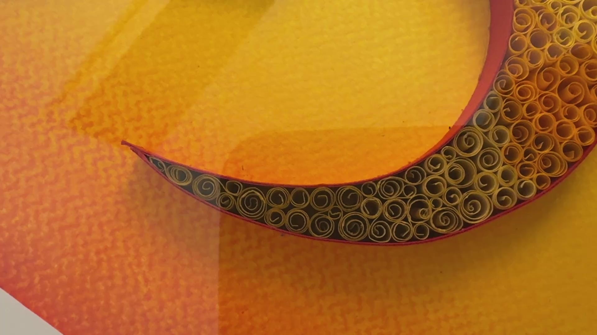 Close up of handcrafted quilling OM design