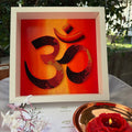 One-of-a-kind paper quilling OM artwork inspired by a red, orange and gold twilight horizon, framed in white MDF