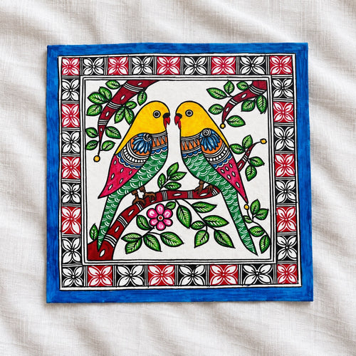 Budgerigar Madhubani artwork with two yellow-headed birds and blue border on white linen