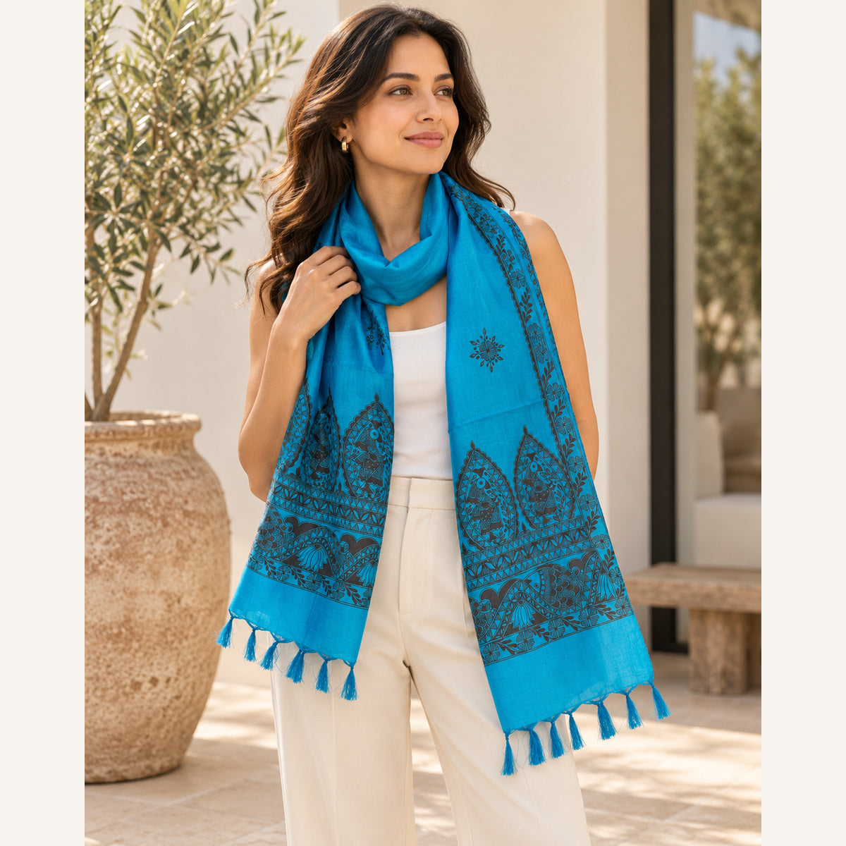 Turquoise Madhubani stole styled with white top and cream trousers